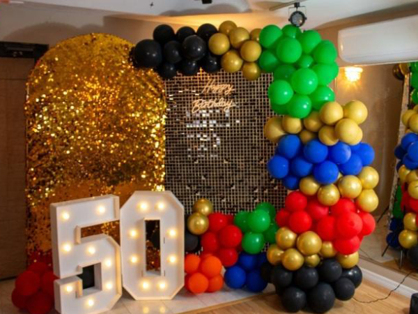 fabulous 50th birthday party with balloon arch backdrops