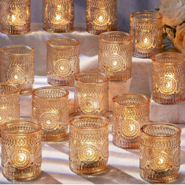 gold votive tea candles on table with flickering light